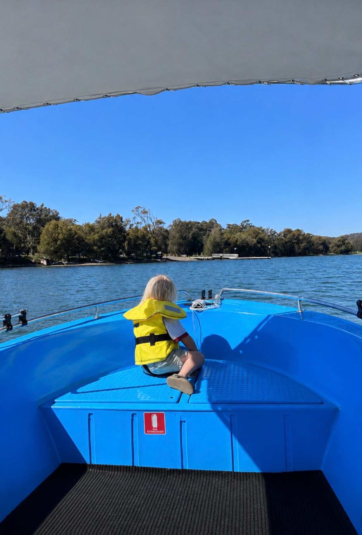 Child in life jacket enjoying a ride on the boat on Lake Macquarie